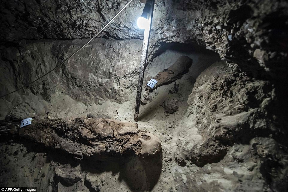 Two mummies in a passageway of the burial site.
