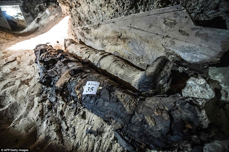 Two mummies, mostly intact, inside the burial site