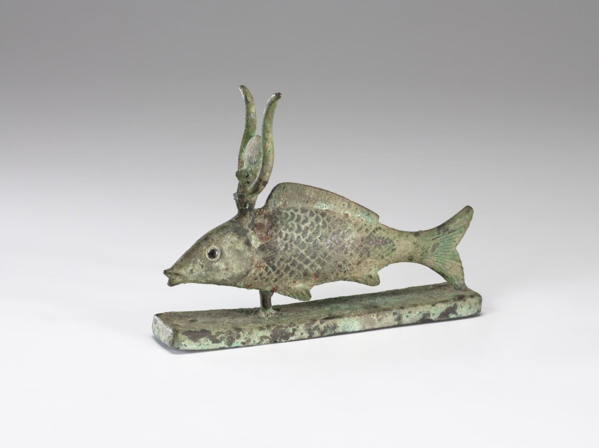 A bronze statuette of the sacred medjed fish with a crown of the goddess isis 