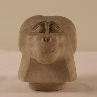 Limestone canopic jar lid in the form of a baboon s head from abydos 