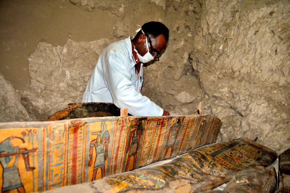 The coffins were covered with intricate drawings in red, blue, black, green, and yellow 