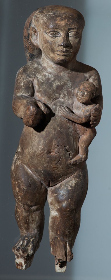 This wooden figurine of a dwarf and child at abydos