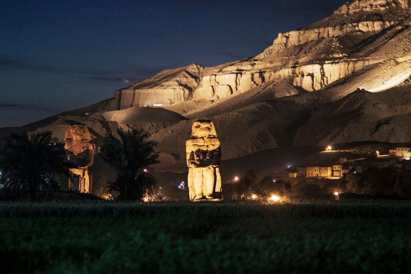 Photo by ashrafezzat remains of the funerary temple of king amenhotep iii aka memnon colossi flanked in the background by the western mountain